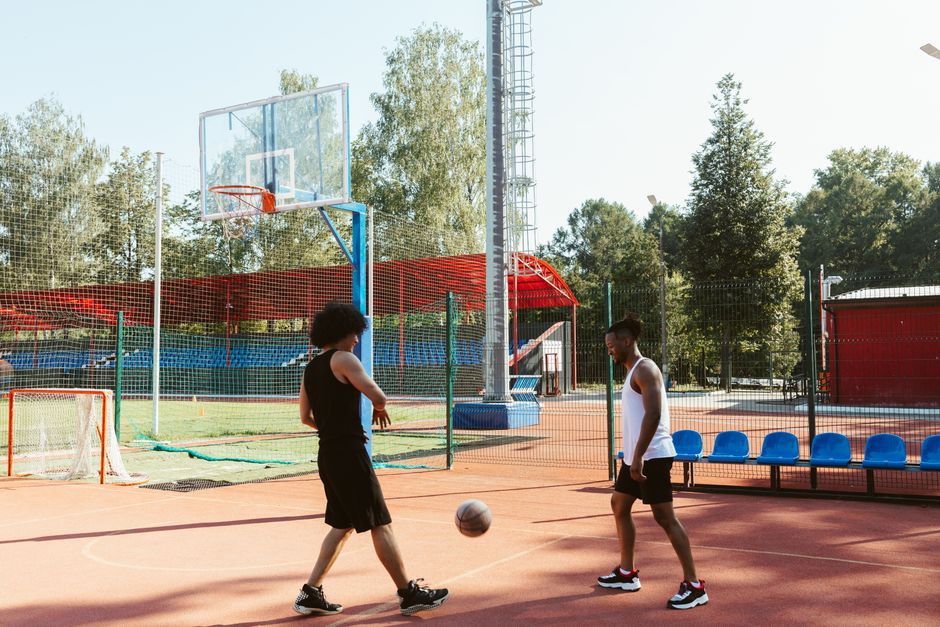 Students playing basketball on an outdoor court